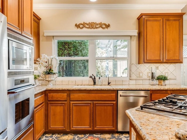 kitchen featuring brown cabinetry, ornamental molding, and stainless steel appliances