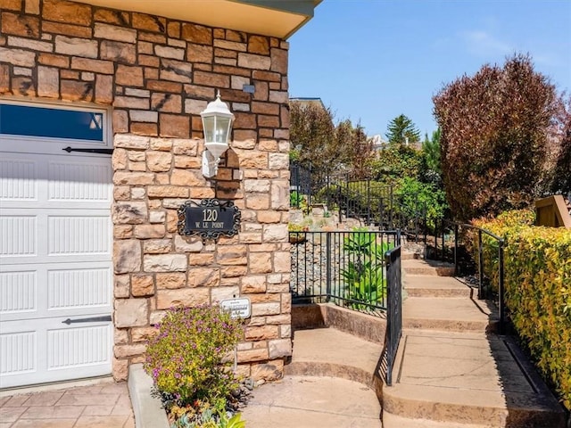 exterior space with fence and stone siding
