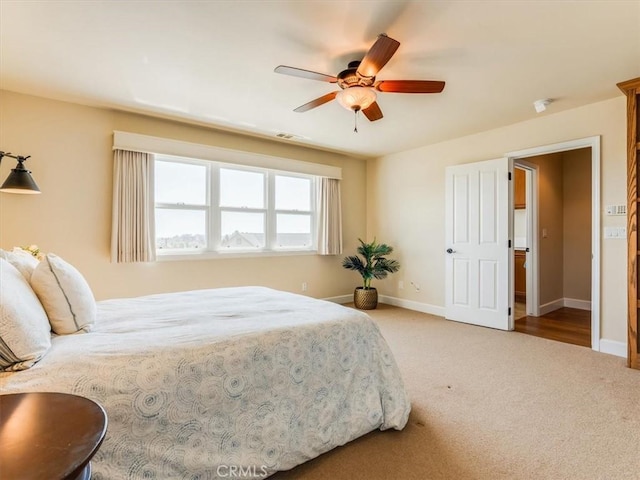 bedroom with visible vents, baseboards, carpet floors, and ceiling fan