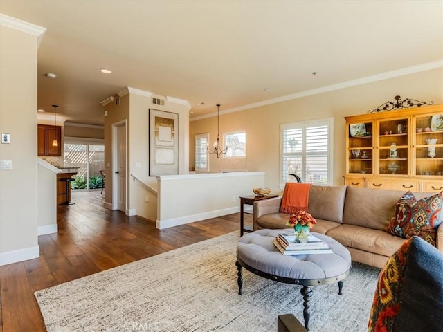 living area featuring baseboards, dark wood-style flooring, visible vents, and a wealth of natural light
