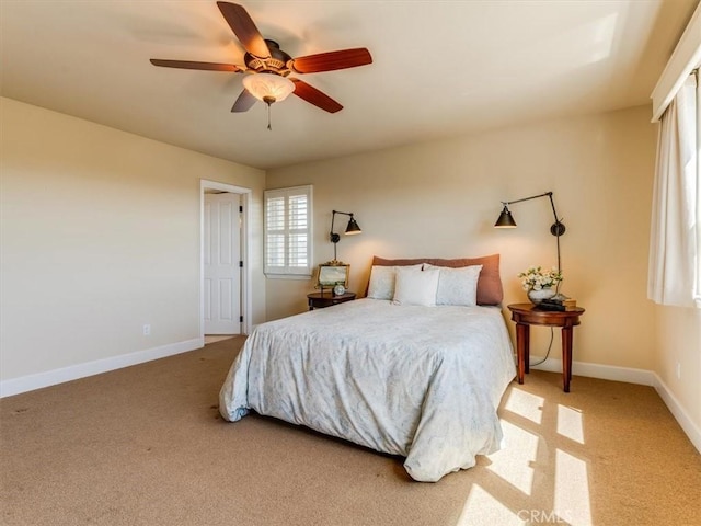carpeted bedroom with baseboards and a ceiling fan