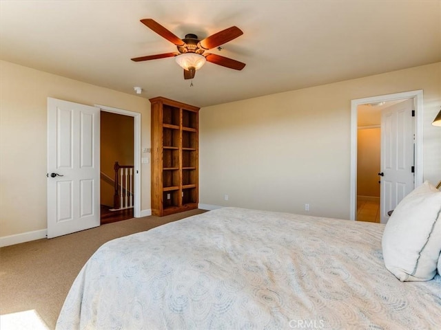 bedroom with carpet floors, a ceiling fan, and baseboards
