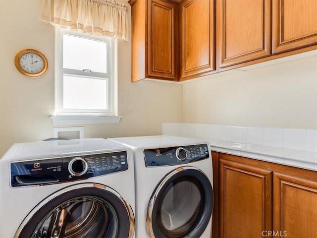 laundry room with cabinet space and independent washer and dryer