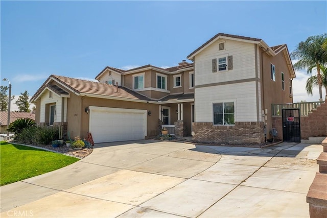 29465 Siderite Cir, Menifee, CA 92584 - view of front of home featuring concrete driveway, brick siding, a garage, and a tiled roof