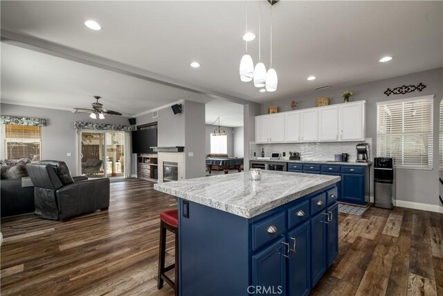 29465 Siderite Cir, Menifee, CA 92584 - kitchen with blue cabinetry, healthy amount of natural light, a chandelier, white cabinets, and recessed lighting