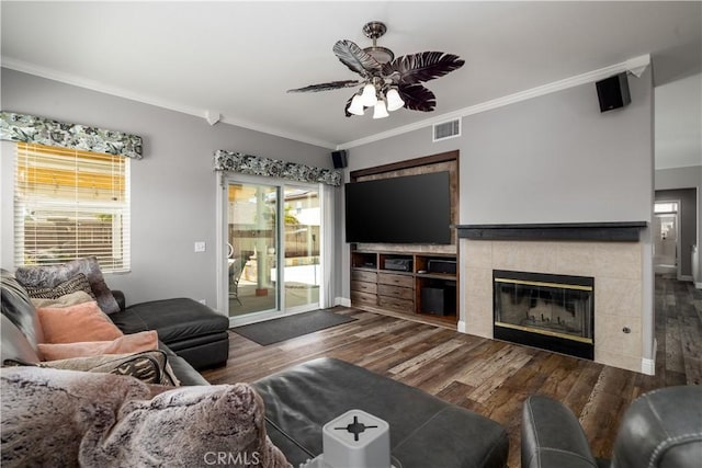 29465 Siderite Cir, Menifee, CA 92584 - living area featuring wood finished floors, a ceiling fan, crown molding, baseboards, and a fireplace