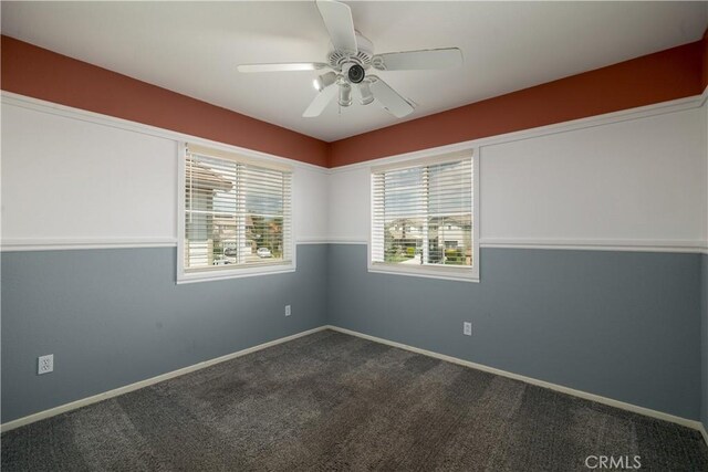29465 Siderite Cir, Menifee, CA 92584 - empty room featuring dark carpet, baseboards, and a ceiling fan