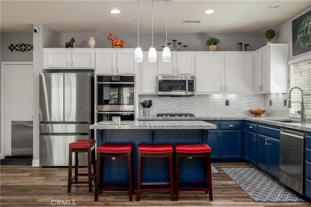 29465 Siderite Cir, Menifee, CA 92584 - kitchen featuring appliances with stainless steel finishes, blue cabinets, a sink, white cabinets, and dark wood finished floors