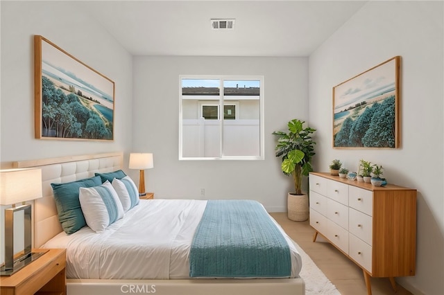 bedroom featuring light wood-style floors and visible vents