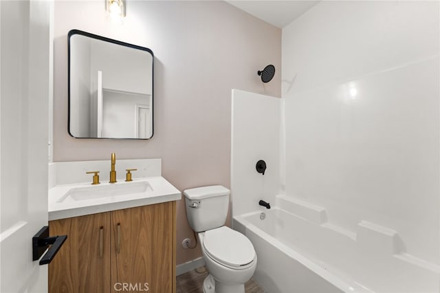 bathroom featuring shower / bath combination, vanity, baseboards, and toilet