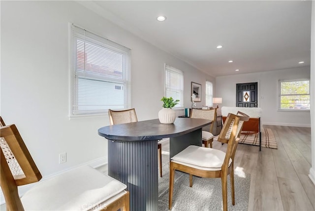 dining area featuring recessed lighting, light wood-style flooring, and baseboards