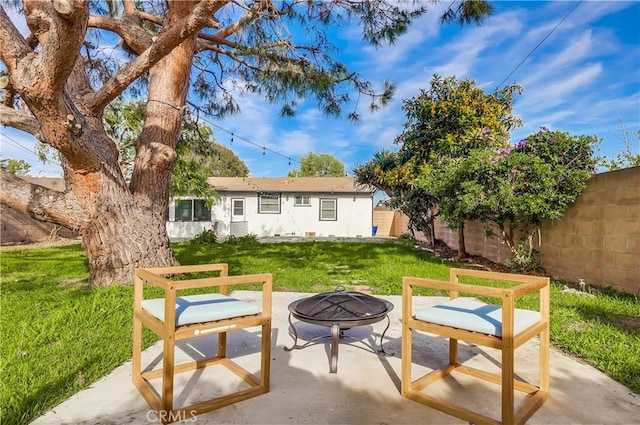 back of property featuring a fenced backyard, a patio area, and a lawn