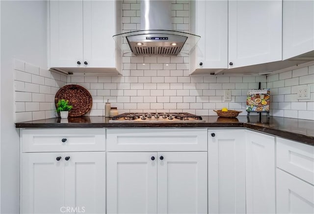 kitchen with island range hood, decorative backsplash, white cabinetry, and stainless steel gas stovetop