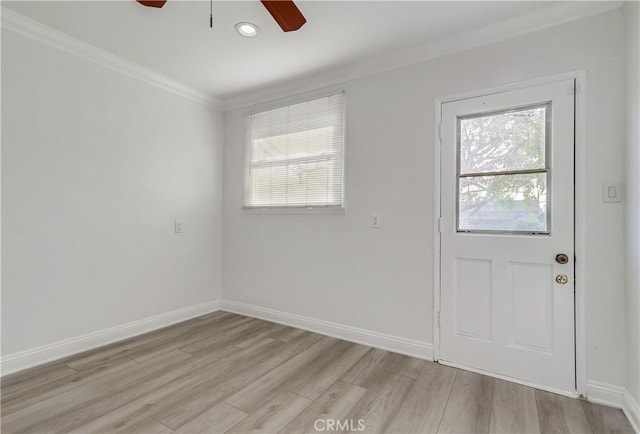 doorway with light wood-style flooring, ceiling fan, ornamental molding, and a wealth of natural light