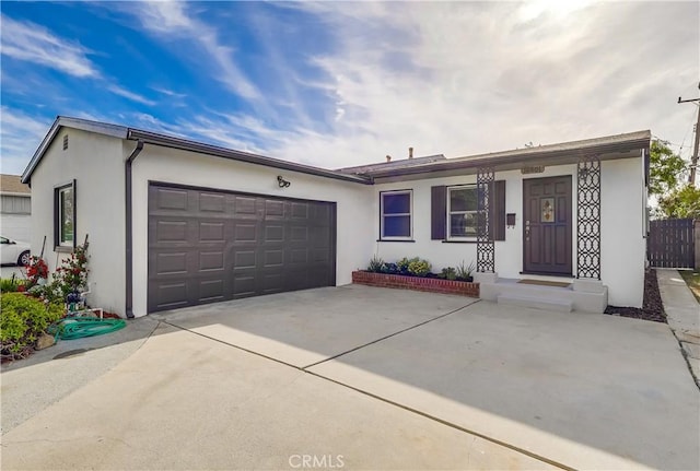 ranch-style house with a garage, driveway, stucco siding, and fence