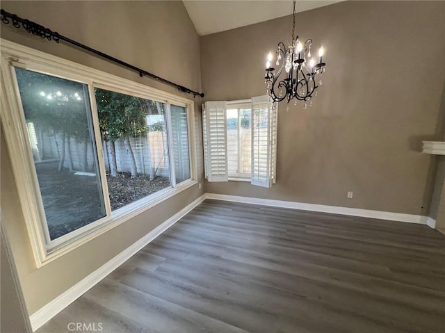 unfurnished dining area with a chandelier, high vaulted ceiling, baseboards, and wood finished floors