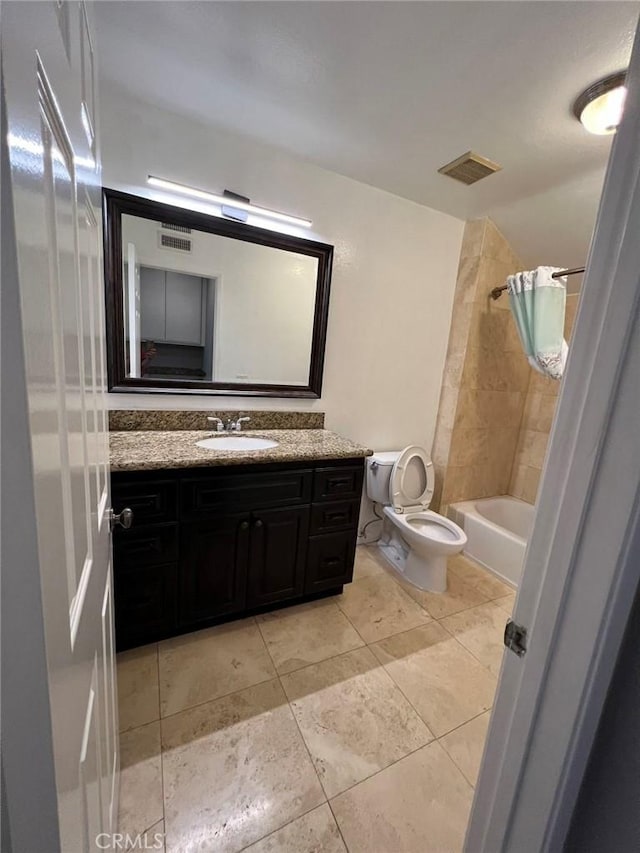 bathroom with toilet, vanity, shower / tub combo with curtain, and visible vents