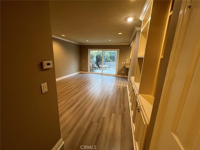 interior space featuring recessed lighting, light wood-style floors, baseboards, and ornamental molding