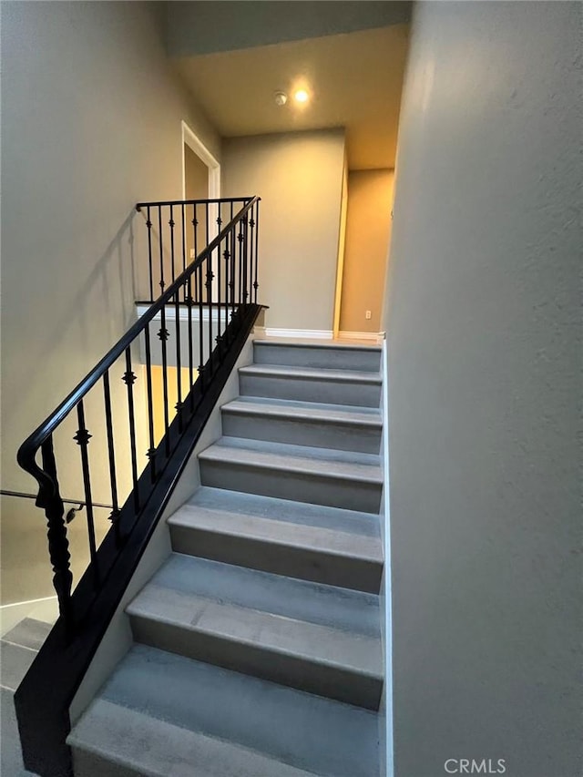 staircase featuring recessed lighting and baseboards