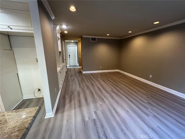 interior space featuring dark wood-style flooring, baseboards, recessed lighting, crown molding, and visible vents