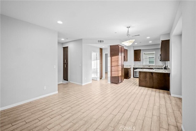 4619 Alekona Ct, Cypress, CA 90630 - kitchen with open floor plan, light wood-style floors, dark brown cabinets, recessed lighting, and a peninsula