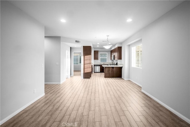 4619 Alekona Ct, Cypress, CA 90630 - kitchen with open floor plan, light wood-type flooring, dark brown cabinetry, light countertops, and recessed lighting