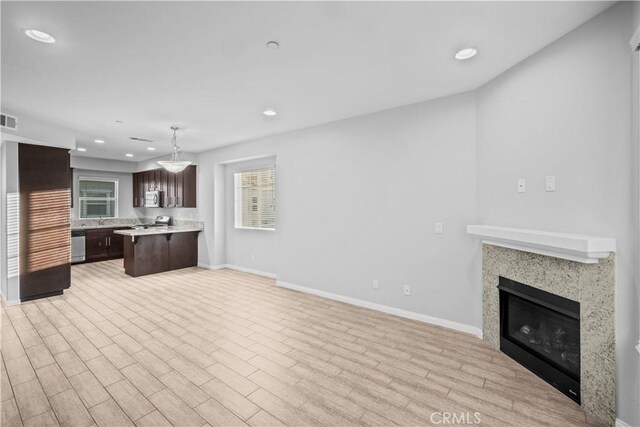 4619 Alekona Ct, Cypress, CA 90630 - kitchen featuring open floor plan, dark brown cabinets, light countertops, recessed lighting, and plenty of natural light