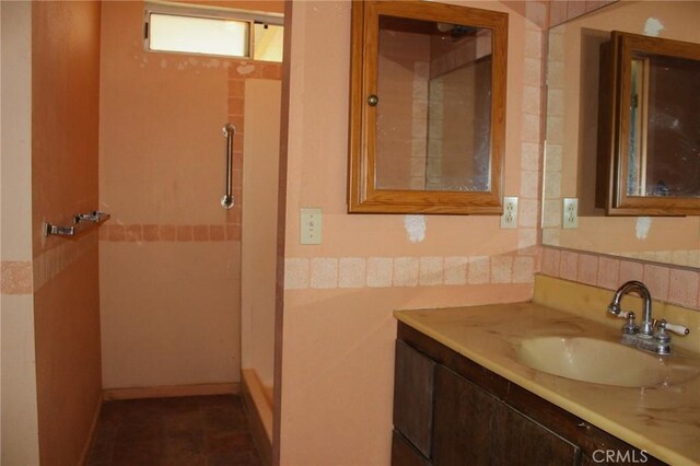 bathroom with vanity and a shower