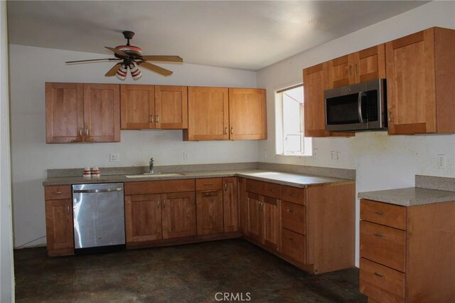 kitchen featuring a sink, appliances with stainless steel finishes, and brown cabinetry