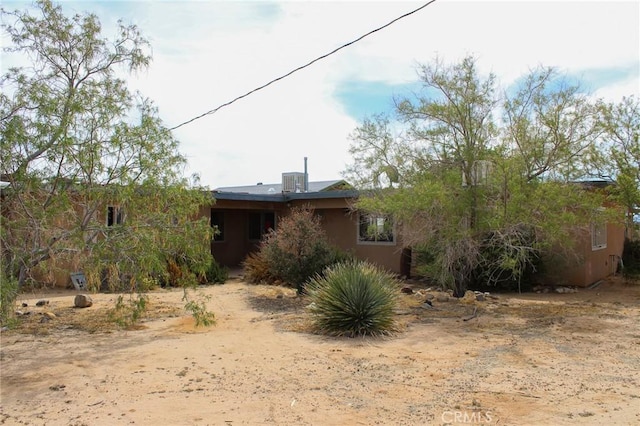 back of property featuring central AC unit