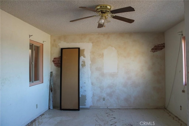 1471 Luna Mesa Rd, Yucca Valley, CA 92284 - unfurnished room featuring a textured ceiling, a ceiling fan, and baseboards