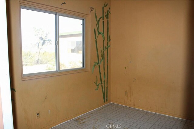 1471 Luna Mesa Rd, Yucca Valley, CA 92284 - unfurnished room featuring baseboards and brick patterned flooring