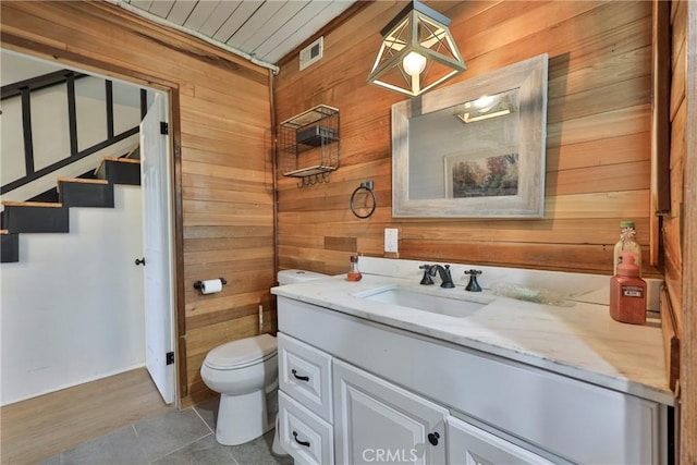 23677 Crest Forest Dr, Crestline, CA 92325 - bathroom with wooden walls, toilet, and vanity