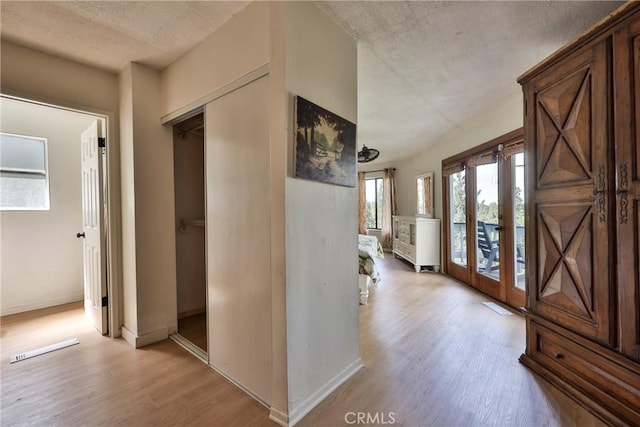 23677 Crest Forest Dr, Crestline, CA 92325 - corridor featuring light wood finished floors, a textured ceiling, and baseboards