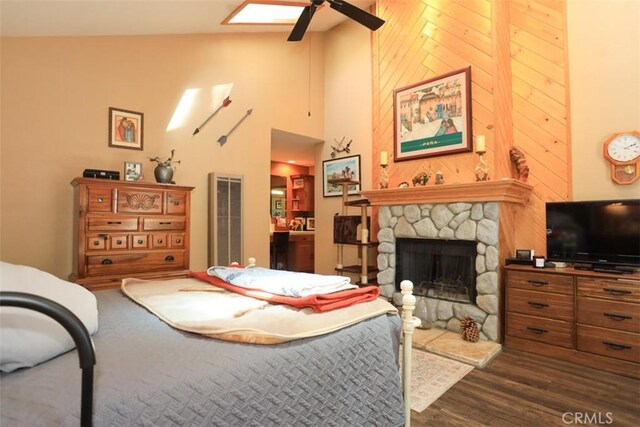 631 Vista Ave, Sugarloaf, CA 92386 - bedroom featuring ceiling fan, a towering ceiling, a fireplace, dark wood finished floors, and wood walls