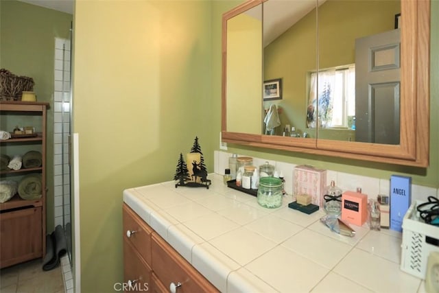 631 Vista Ave, Sugarloaf, CA 92386 - bathroom featuring lofted ceiling, tile patterned flooring, and vanity