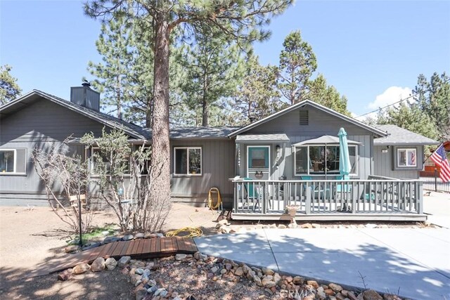 631 Vista Ave, Sugarloaf, CA 92386 - view of front of property featuring a chimney, a patio, and a deck