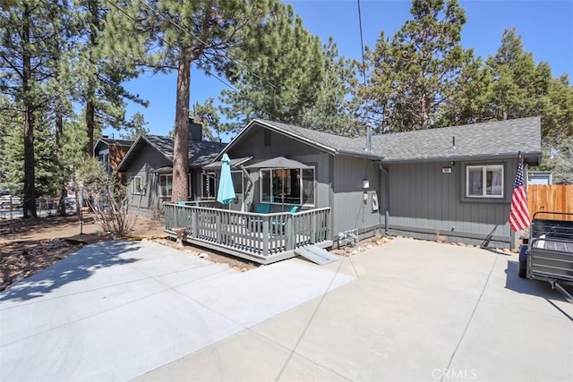 631 Vista Ave, Sugarloaf, CA 92386 - exterior space with fence, a patio area, a shingled roof, and a deck