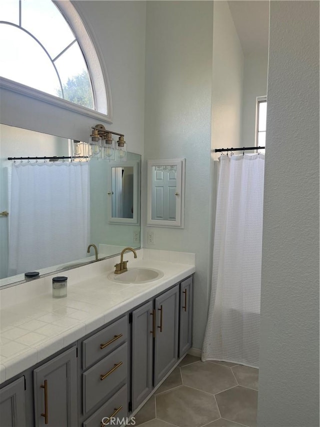 full bath featuring tile patterned floors, curtained shower, and vanity