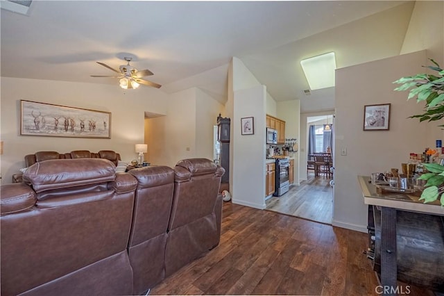 living room featuring baseboards, a ceiling fan, lofted ceiling, and wood finished floors