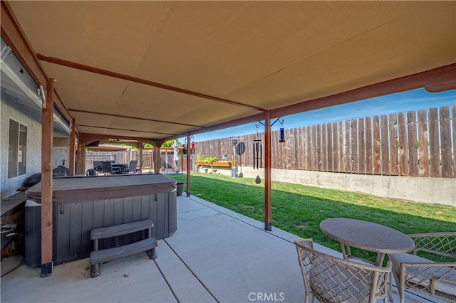 view of patio / terrace featuring a fenced backyard and a hot tub