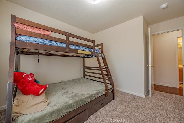 bedroom with carpet floors and baseboards