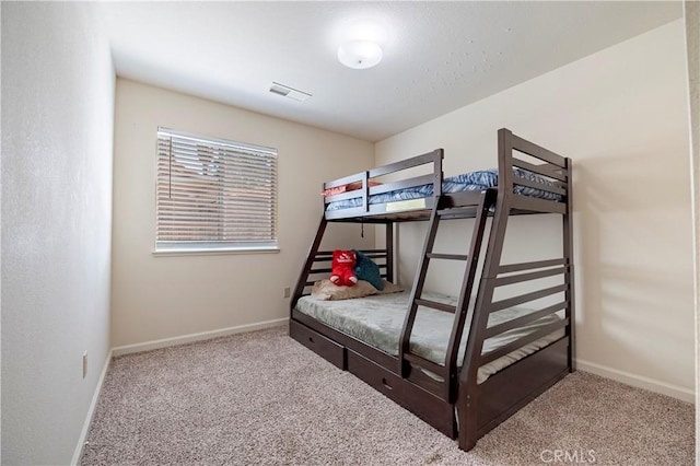 bedroom with baseboards, carpet, and visible vents