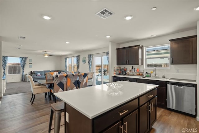 kitchen with a sink, open floor plan, a wealth of natural light, and dishwasher