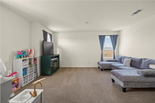living area with baseboards, carpet, and visible vents
