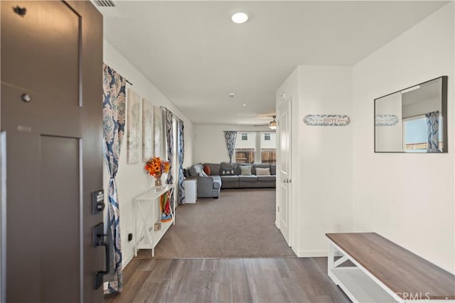 hall with visible vents, carpet floors, recessed lighting, wood finished floors, and baseboards