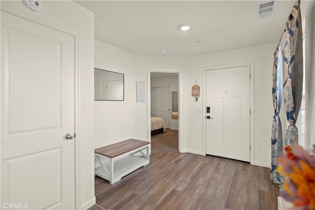 entrance foyer with wood finished floors, baseboards, and visible vents