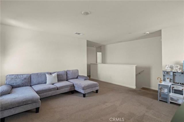 living room featuring carpet flooring, visible vents, and baseboards