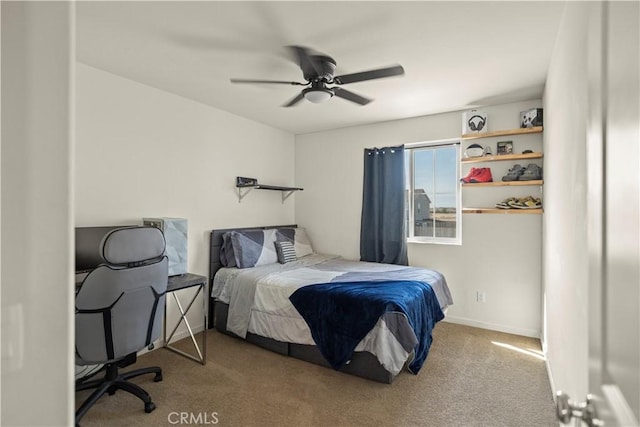 bedroom with ceiling fan, baseboards, and carpet floors