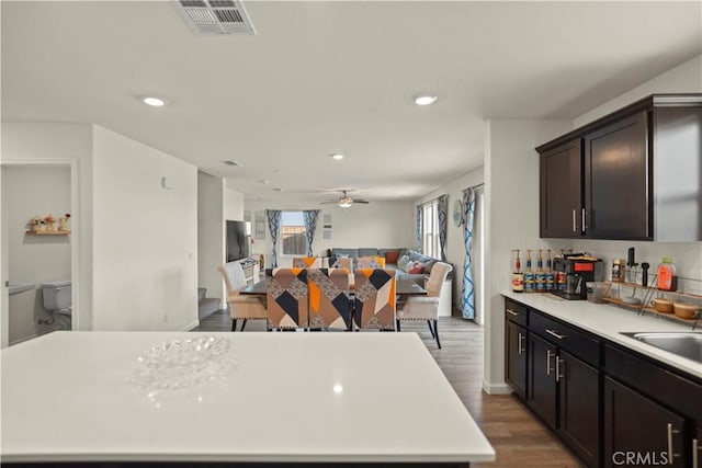 kitchen with visible vents, recessed lighting, wood finished floors, light countertops, and open floor plan